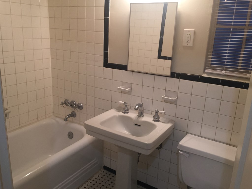 a bathroom with a sink and a toilet and a bath tub