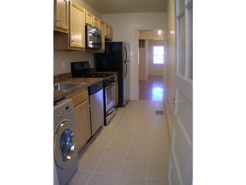 a kitchen with stainless steel appliances and a washer and dryer