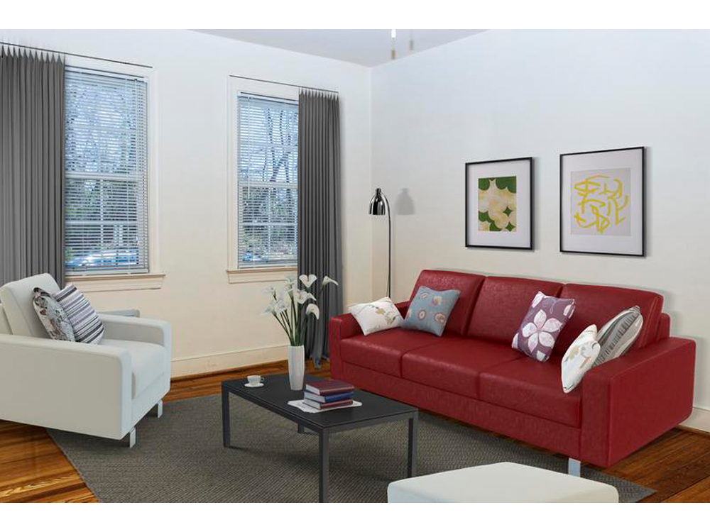 a living room with a red couch and a coffee table