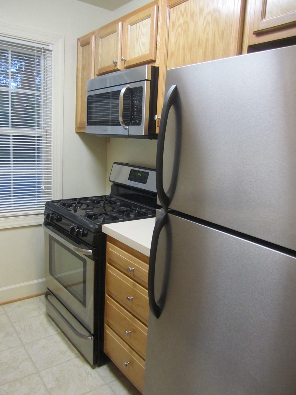 a kitchen with a stainless steel refrigerator and a stove