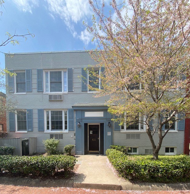 a blue house with a tree in front of it
