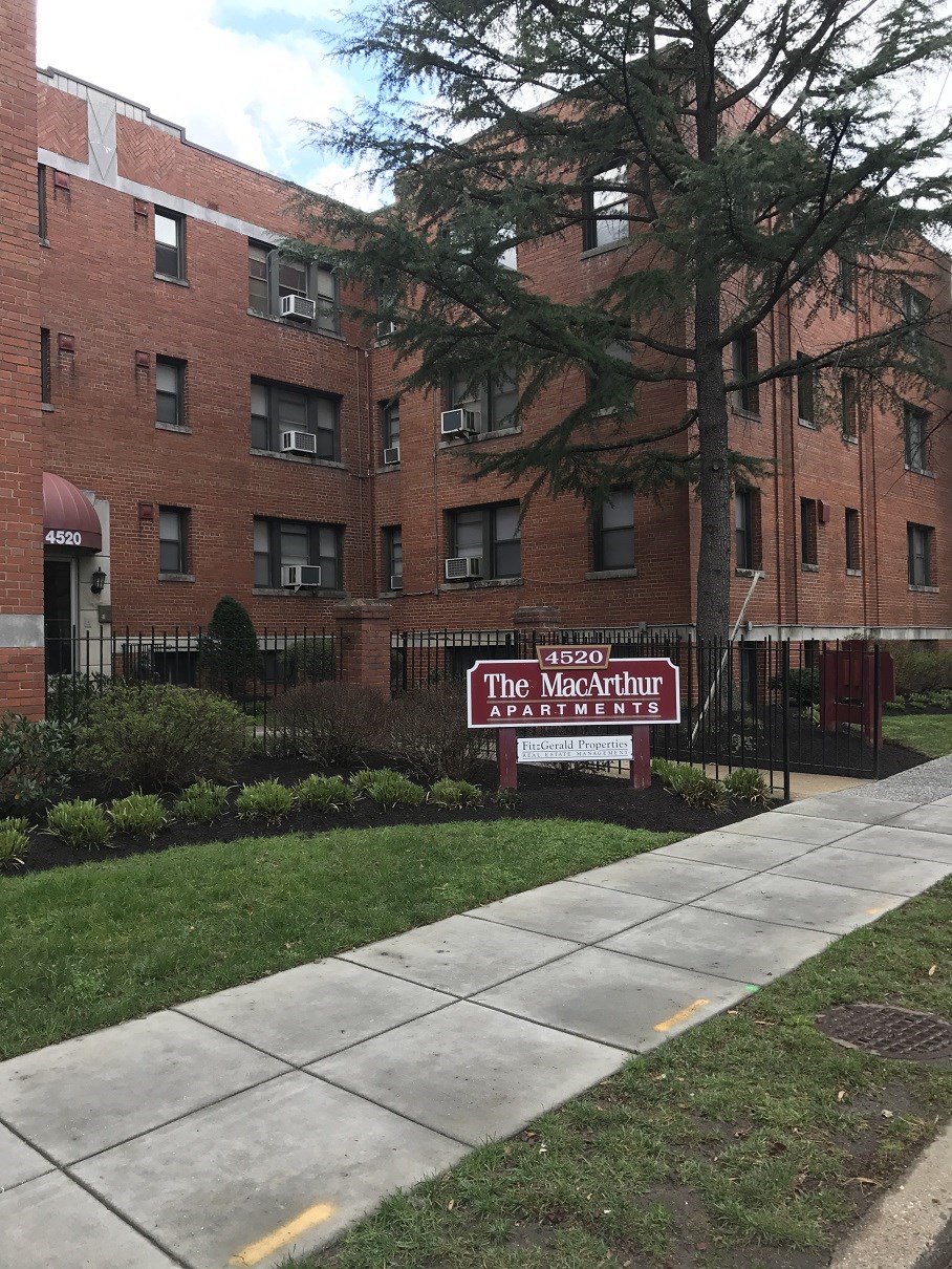 a red sign in front of a brick building