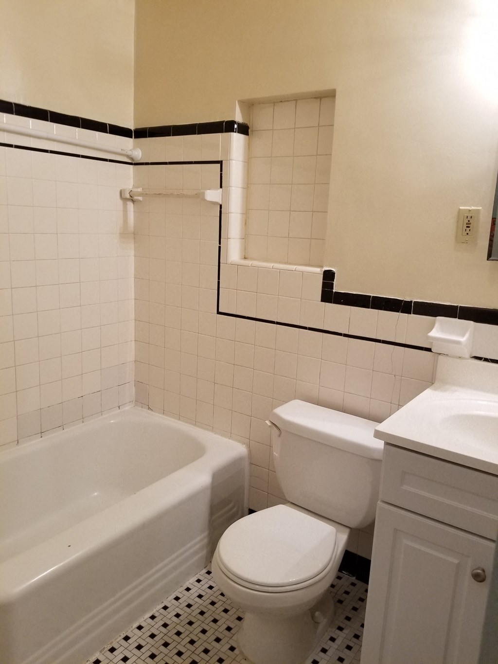 a white bathroom with a toilet and a bath tub
