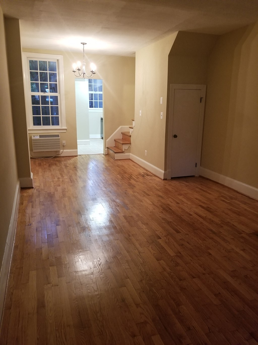 an empty living room with a hard wood floor