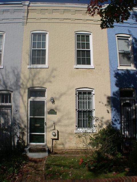 the outside of a house with a door and windows