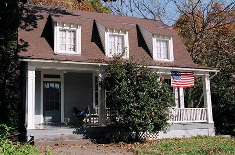 a house with an flag on the porch