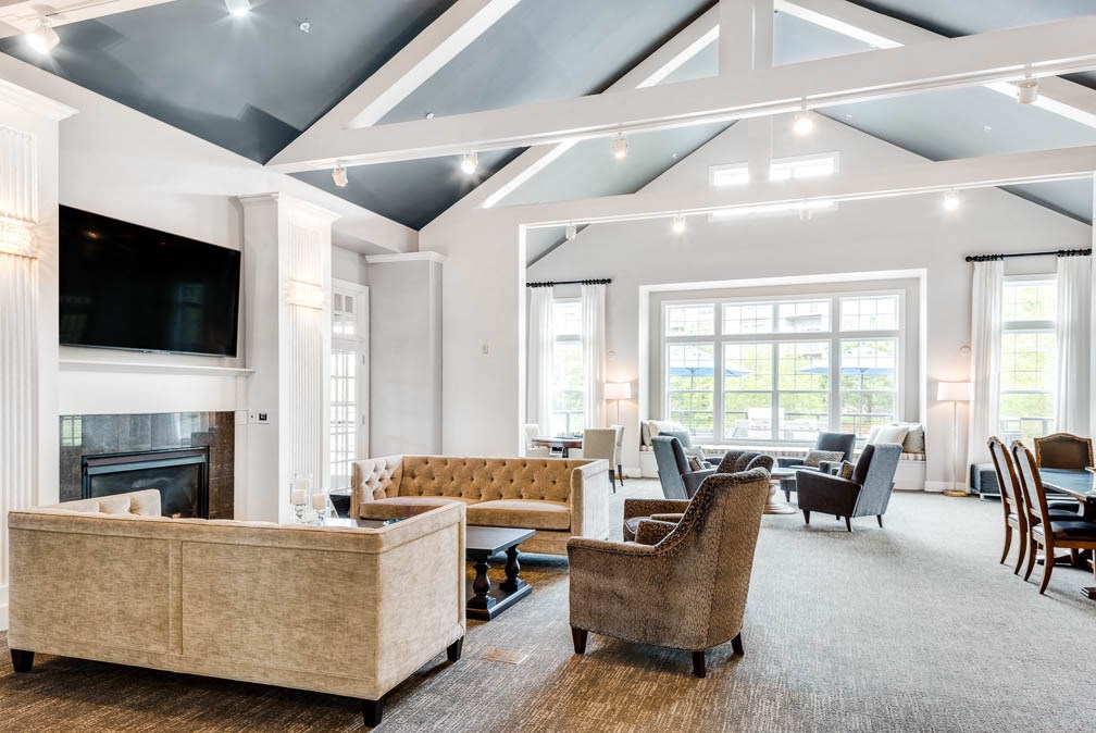 a large living room with couches and chairs and a fireplace