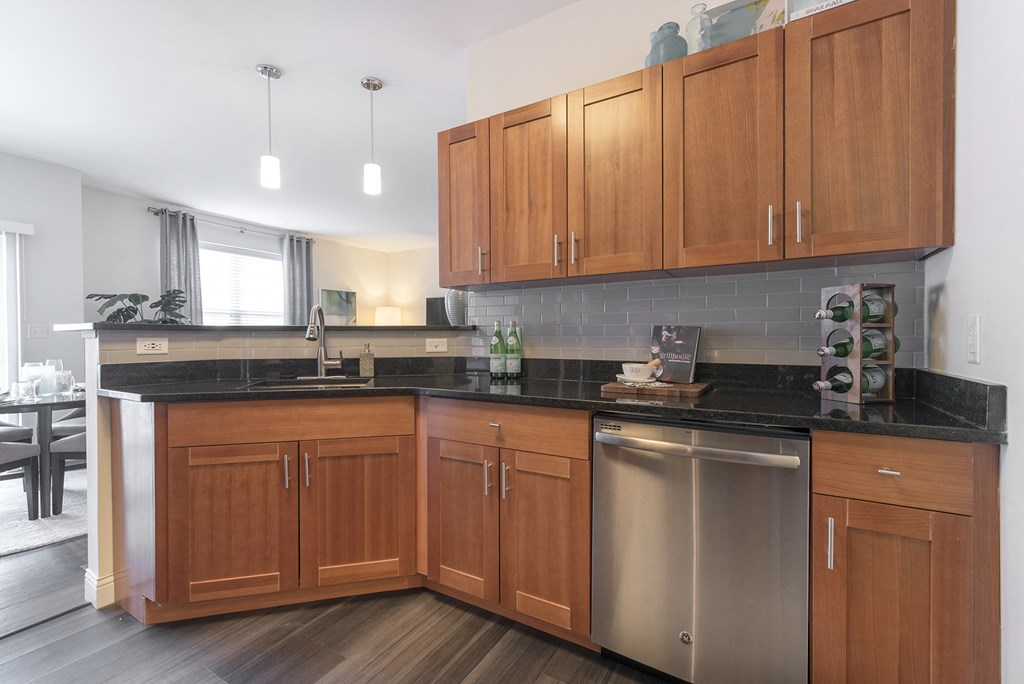 a kitchen with wooden cabinets and stainless steel appliances