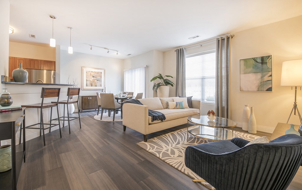 a living room and kitchen with a couch and a table