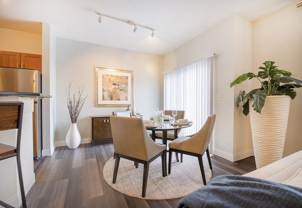 a living room and dining room with a table and chairs