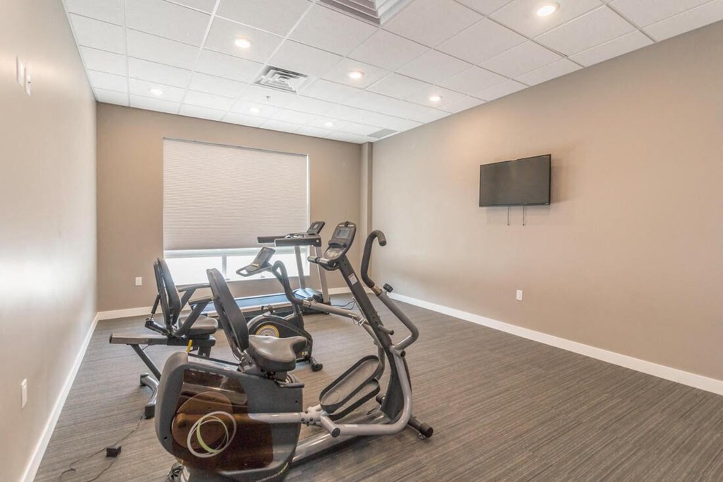 a gym with weights and a tv