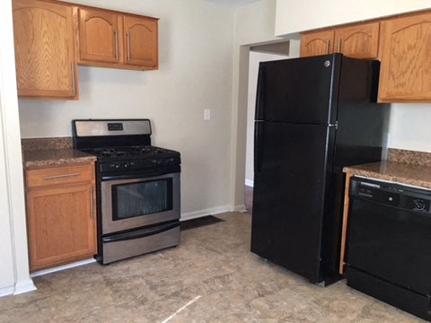 a kitchen with a stove and a refrigerator