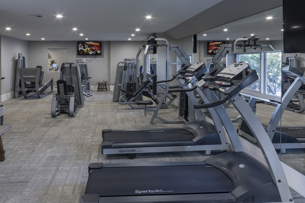 a gym with treadmills and other exercise equipment in a building