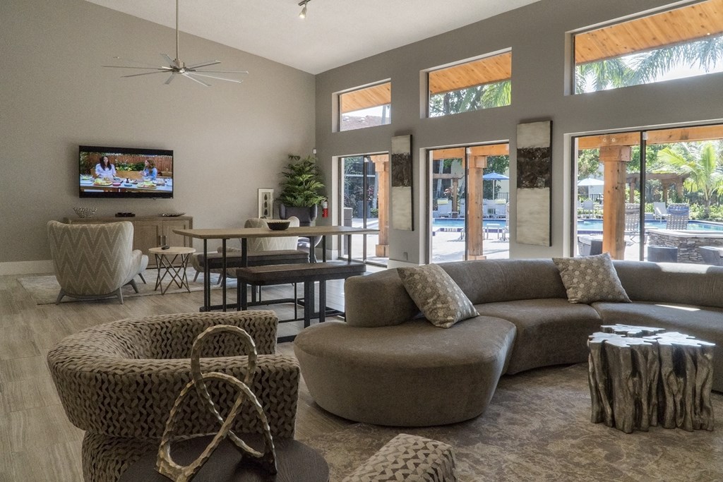 a living room with couches and chairs and a tv