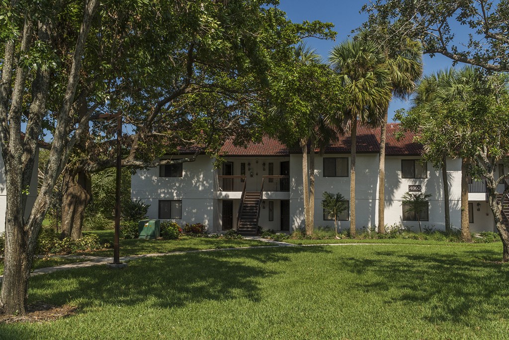 a white house with trees in front of it