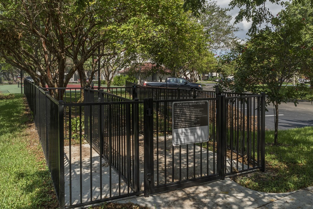 a gate with a sign on it in front of a fence