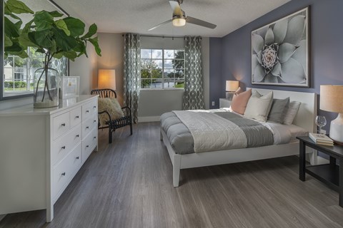 a bedroom with a bed and a dresser and a window