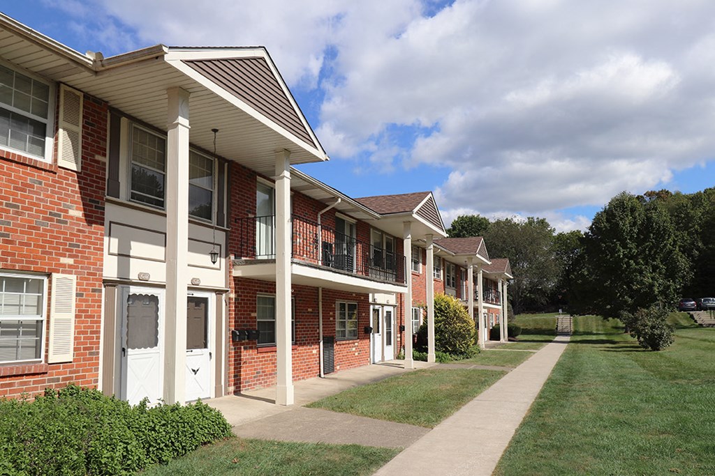 a row of brick apartment buildings on a cloudy day
