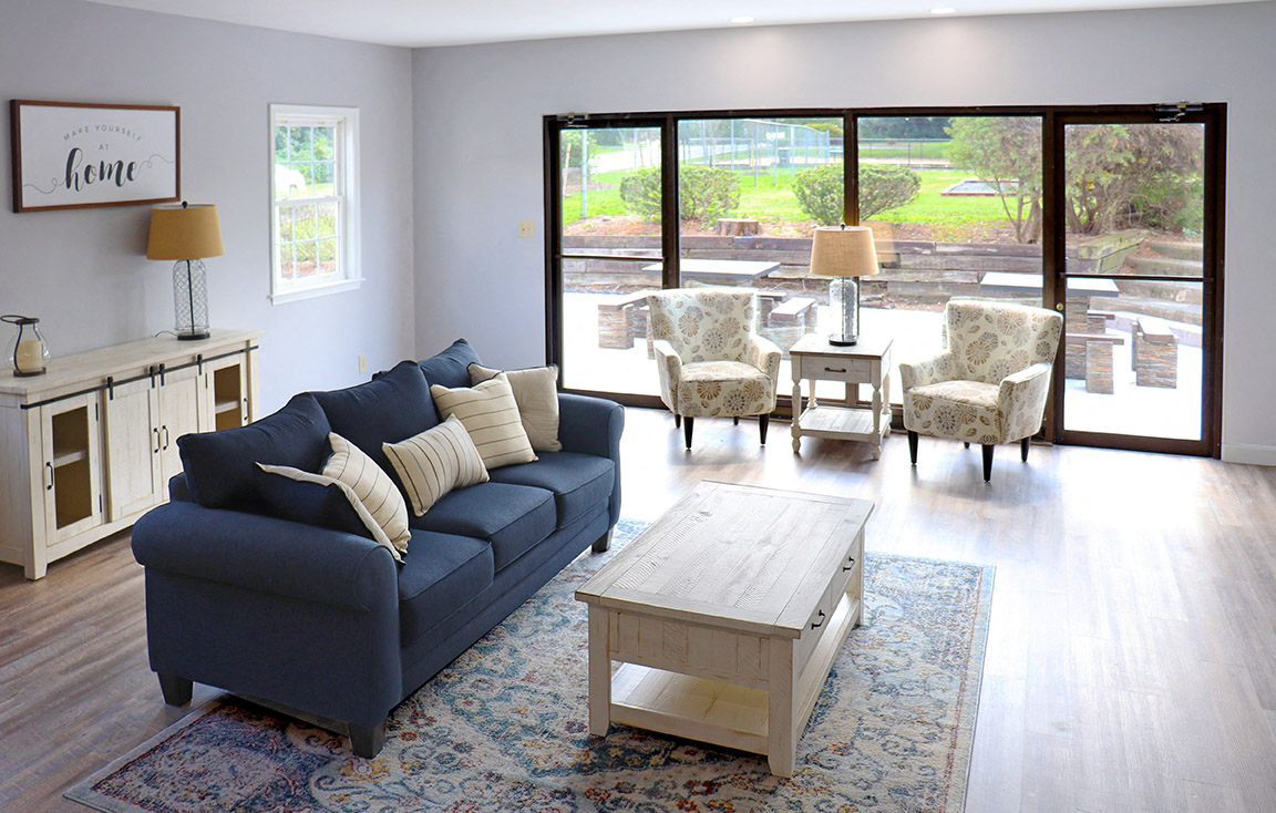 a living room with a blue couch and a coffee table