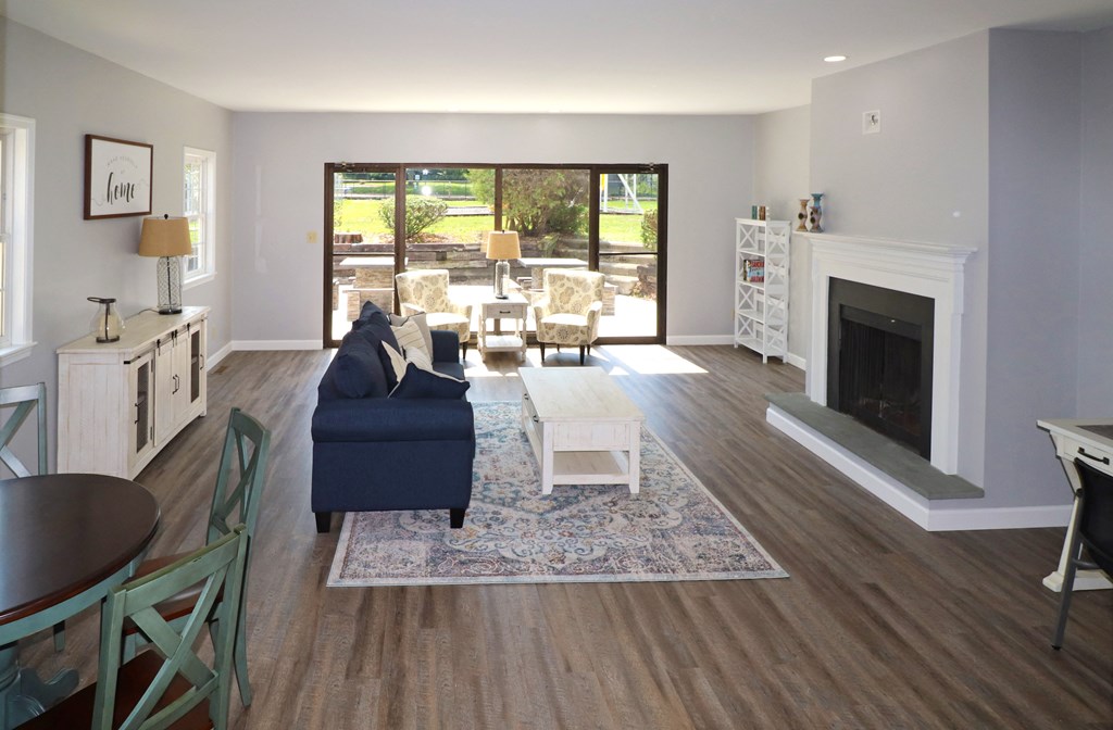 a living room with a blue couch and a fireplace