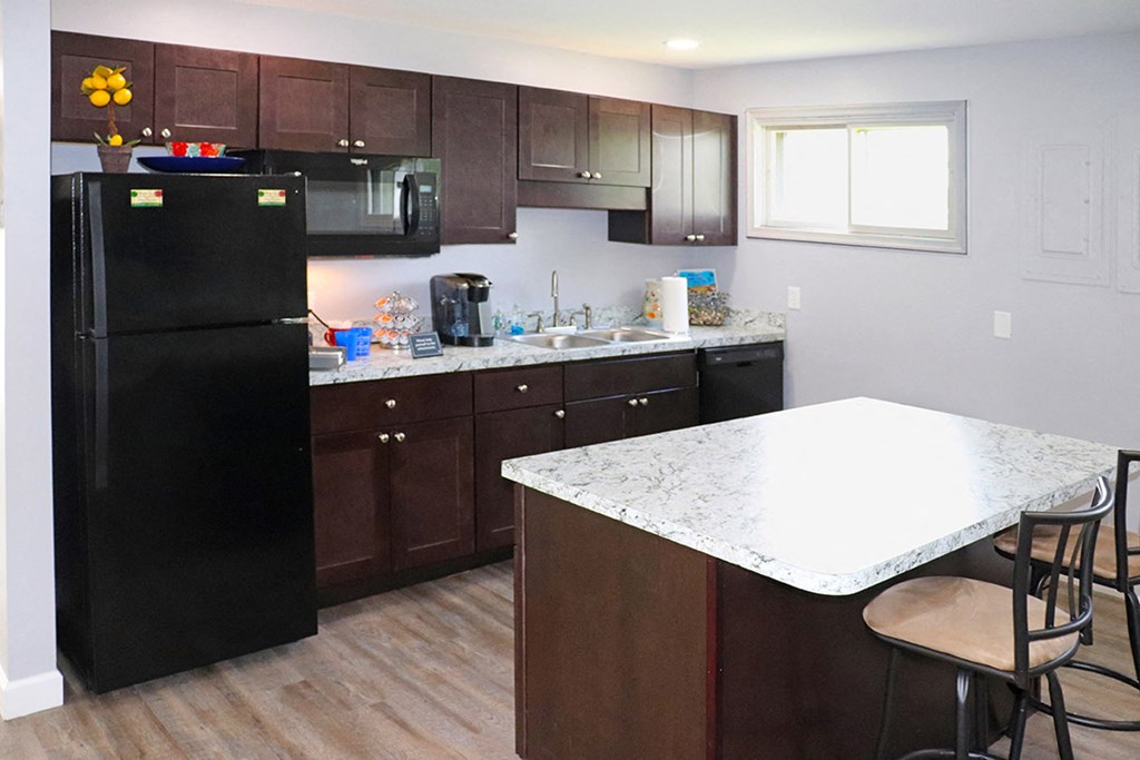 a kitchen with black appliances and a white counter top