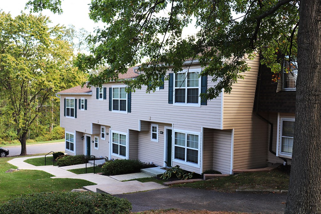 a white house with a tree in front of it