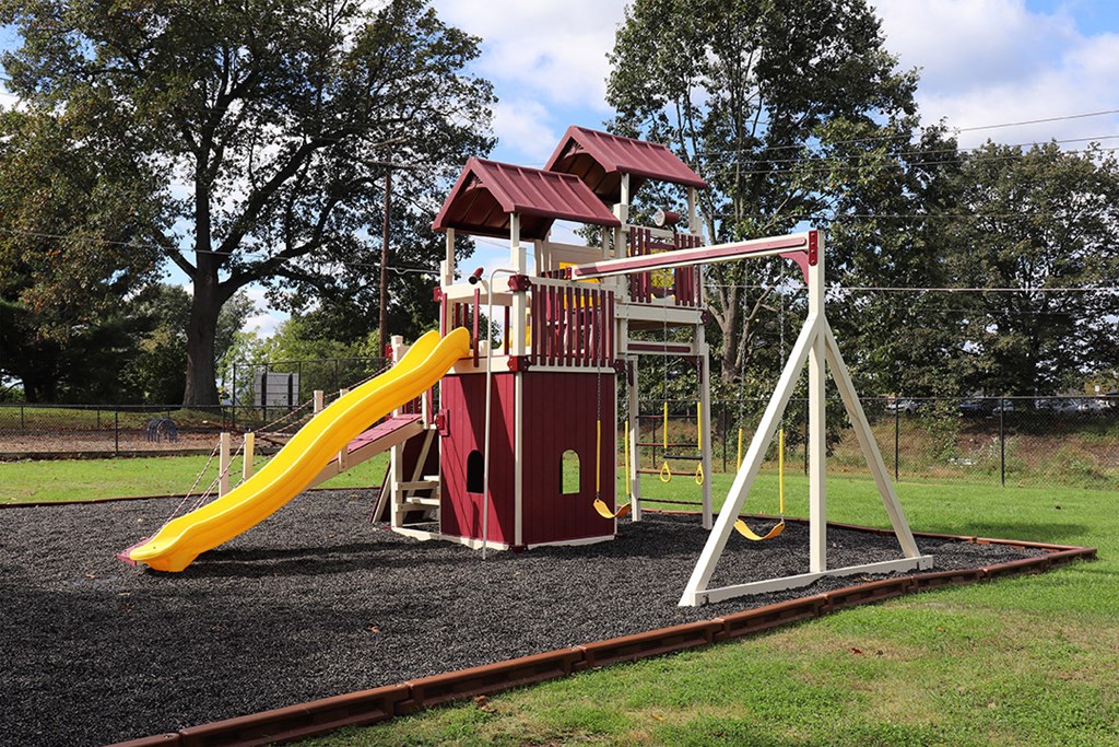 a playground with a swing set and a slide