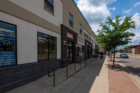 the side of a building with a sidewalk and a street