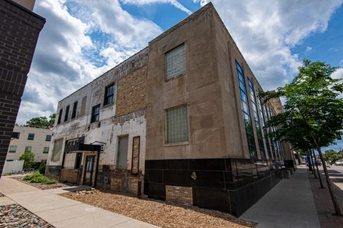 an old building on the side of a sidewalk