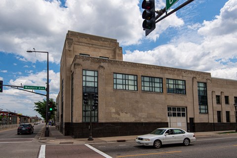 an old building on the corner of a street with a traffic light