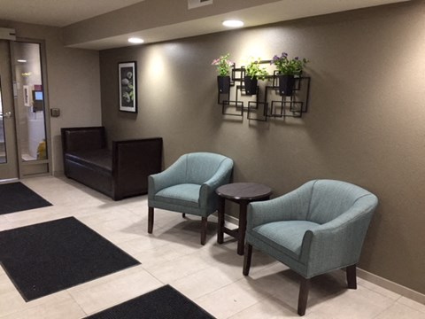 a lobby with two chairs and a table