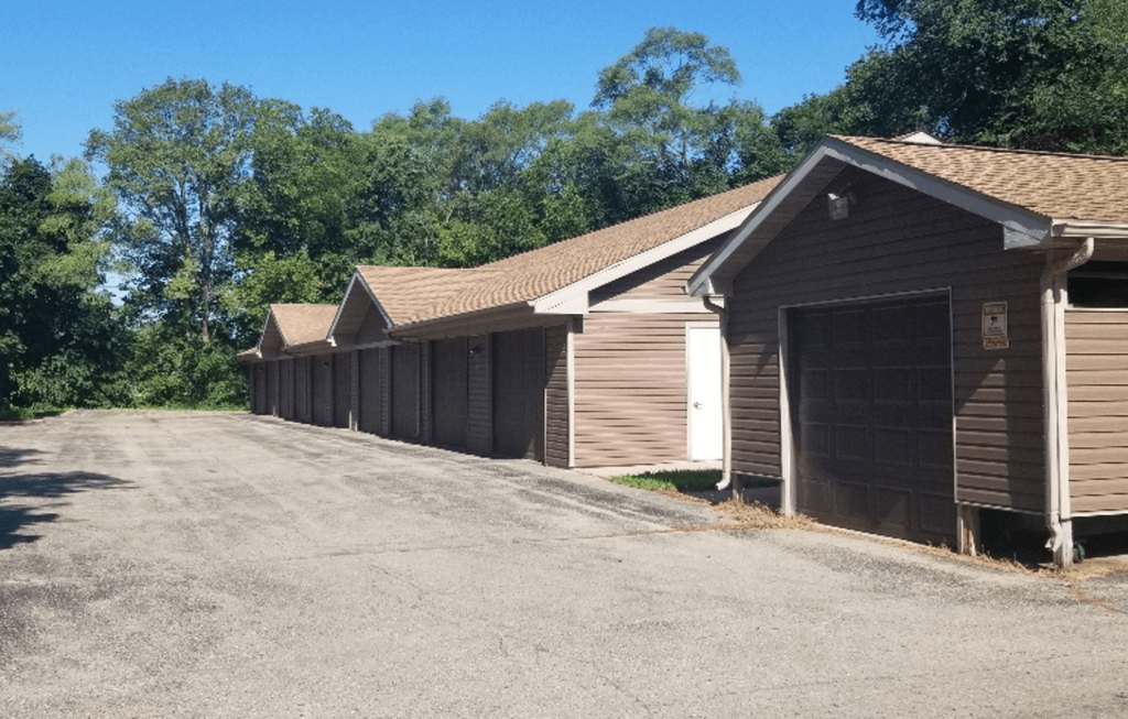 a row of garages with a road in front of them
