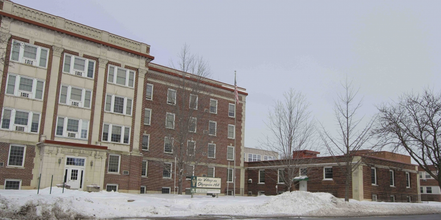 a large brick building with snow in front of it