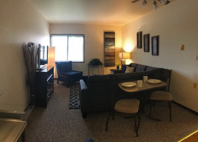 a living room and dining room with a couch and a table