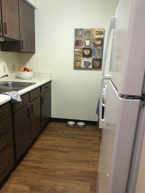 a small kitchen with a refrigerator and a sink