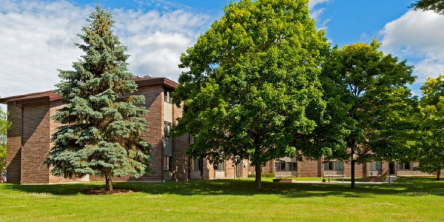 a large brick building with trees in front of it