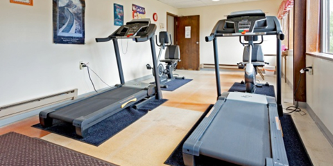 A gym with treadmills and exercise equipment.