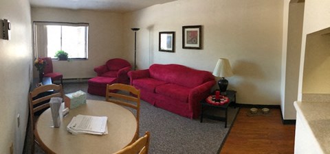 a living room with a red couch and a table