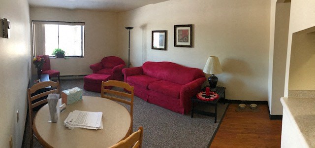 a living room with a red couch and a table