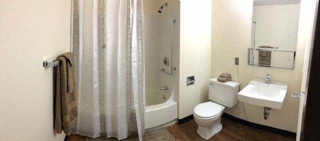a bathroom with a toilet and a sink and a shower