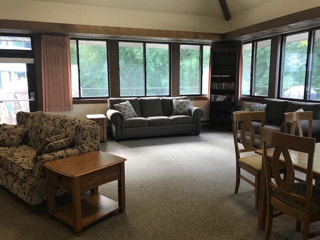 a living room with couches and chairs and a table