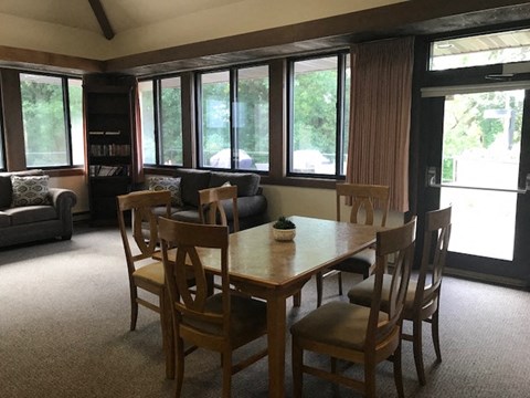 a dining room with a wooden table and chairs