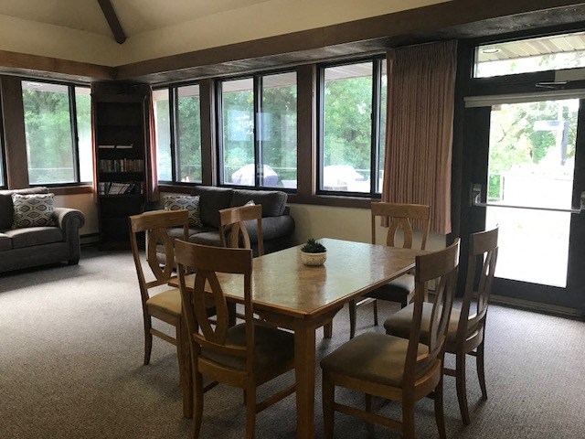 a dining room with a wooden table and chairs
