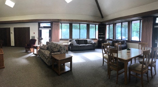 a living room with couches and chairs and a table