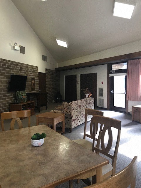 a living room with a wooden table and chairs