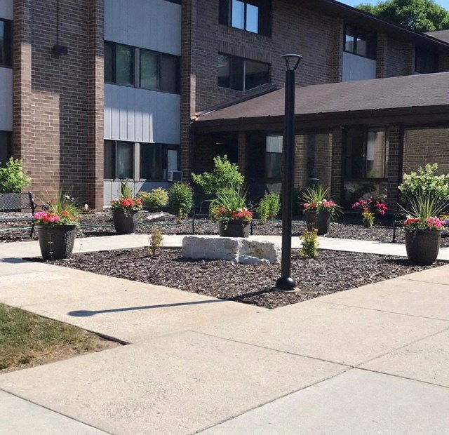 a courtyard with potted plants in front of a building