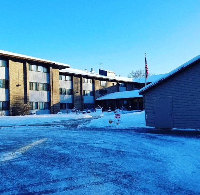 a building with a flag in front of it in the snow