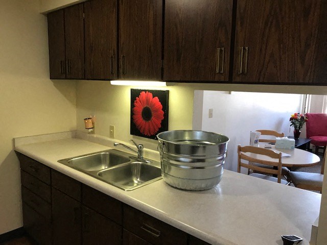 a kitchen with a stainless steel pot on the counter