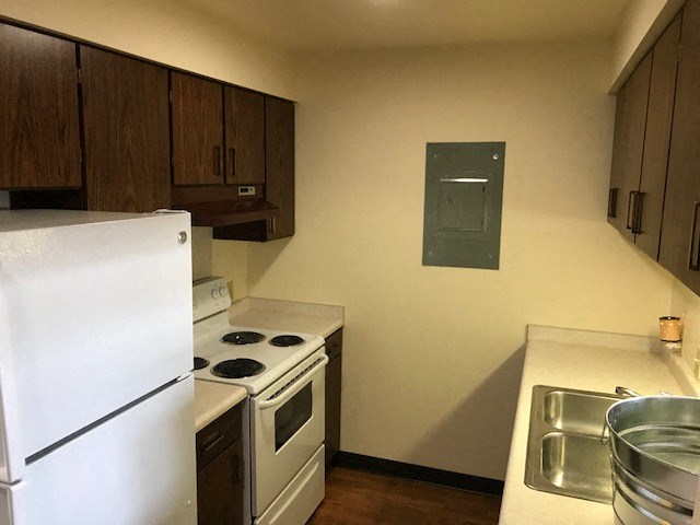 a kitchen with a stove refrigerator and a sink