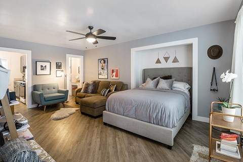 a bedroom with a large bed and a living room with a couch